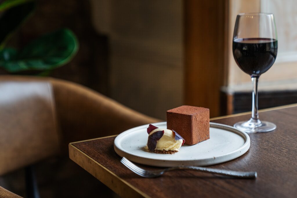 chocolate cube fine dining dessert in bristol with a glass of red wine